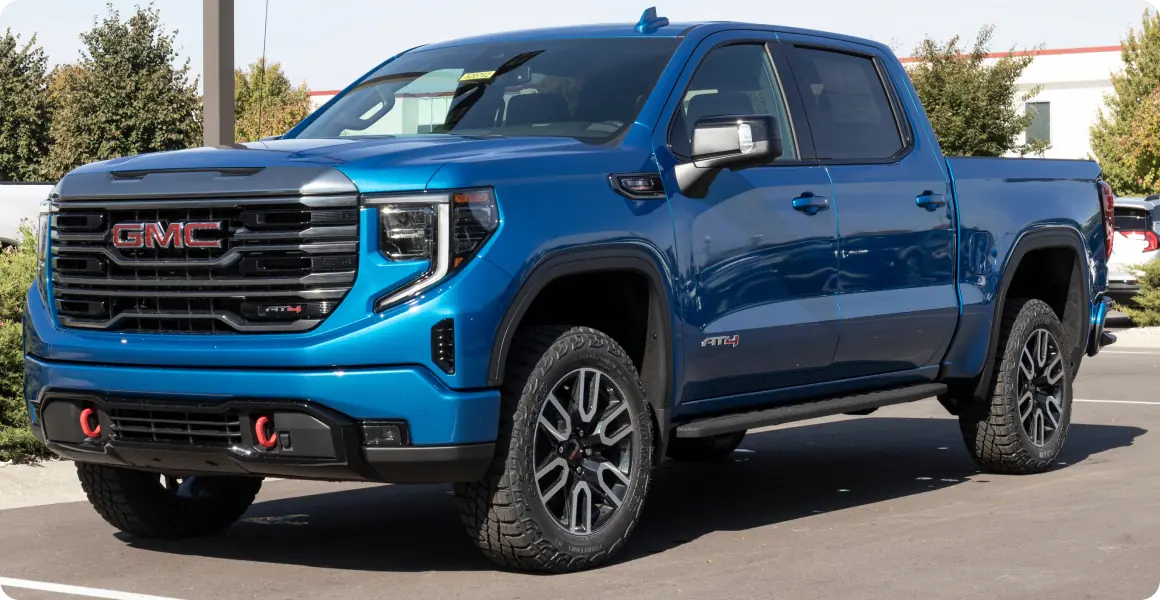 Blue GMC truck with aggressive styling.