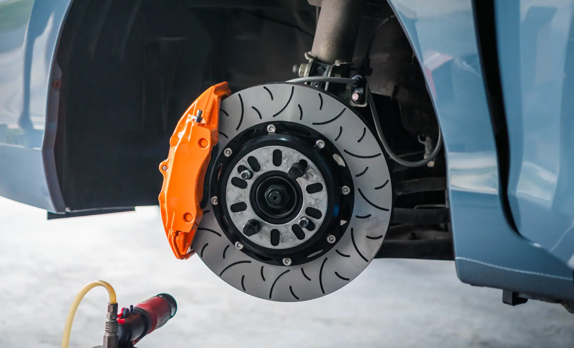 Brake repair in Albuquerque, NM by Albuquerque Auto Repair and Tire. Image of a vehicle brake rotor and caliper during service, highlighting safety and performance care.