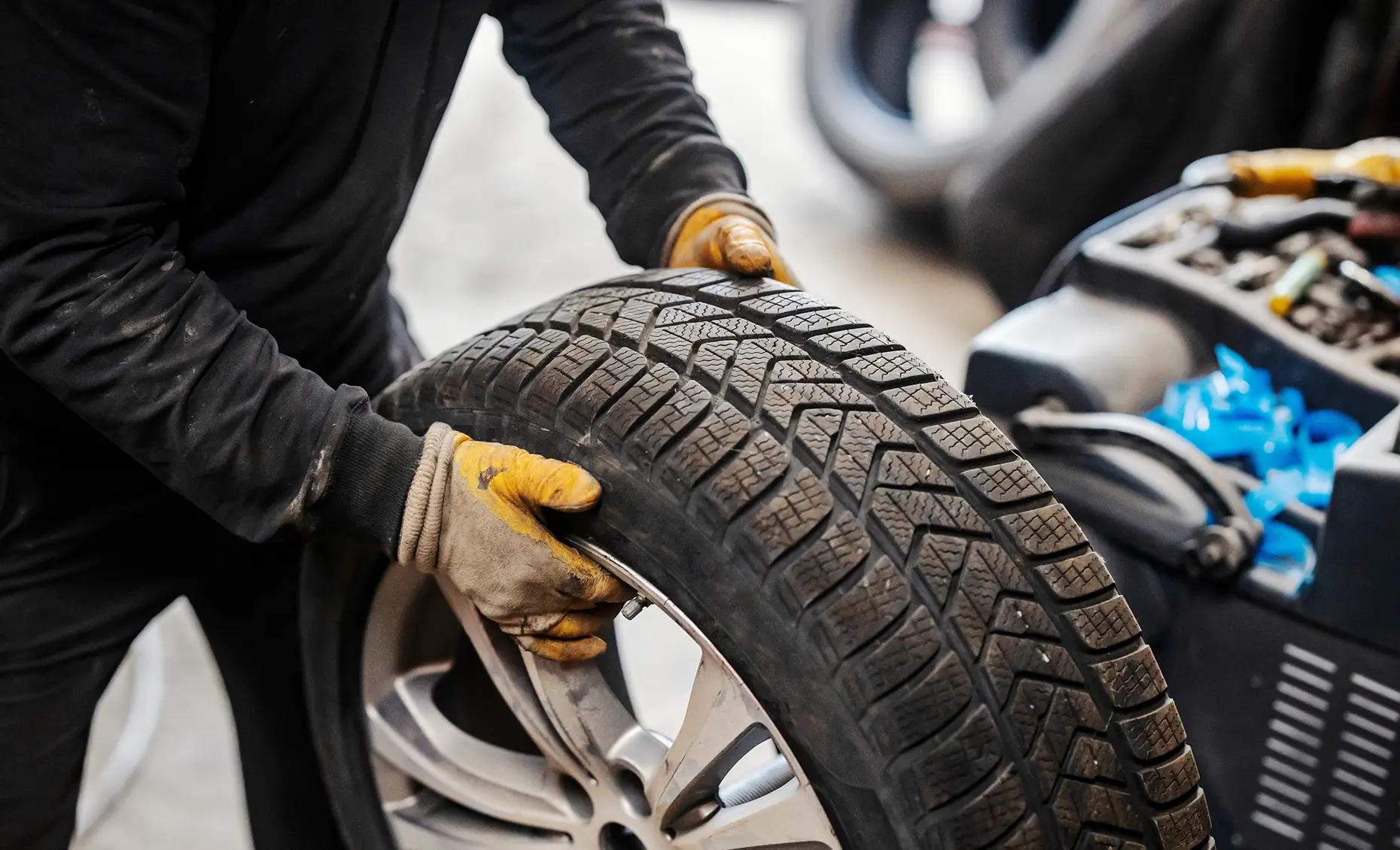 Tire services in Albuquerque, NM by Albuquerque Auto Repair and Tire. Image of a technician handling a tire during service, reinforcing safety and dependable performance.