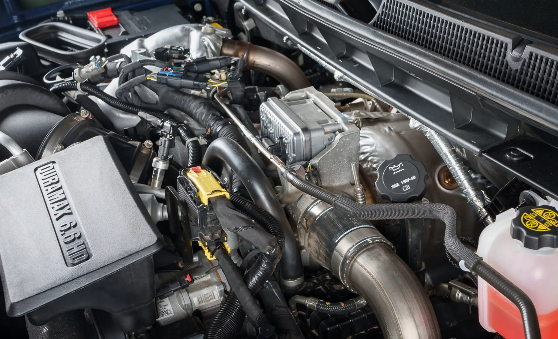 Diesel repair in Albuquerque, NM by Albuquerque Auto Repair and Tire. Image of a Duramax 6.6L engine under the hood, emphasizing power, performance, and expert maintenance.