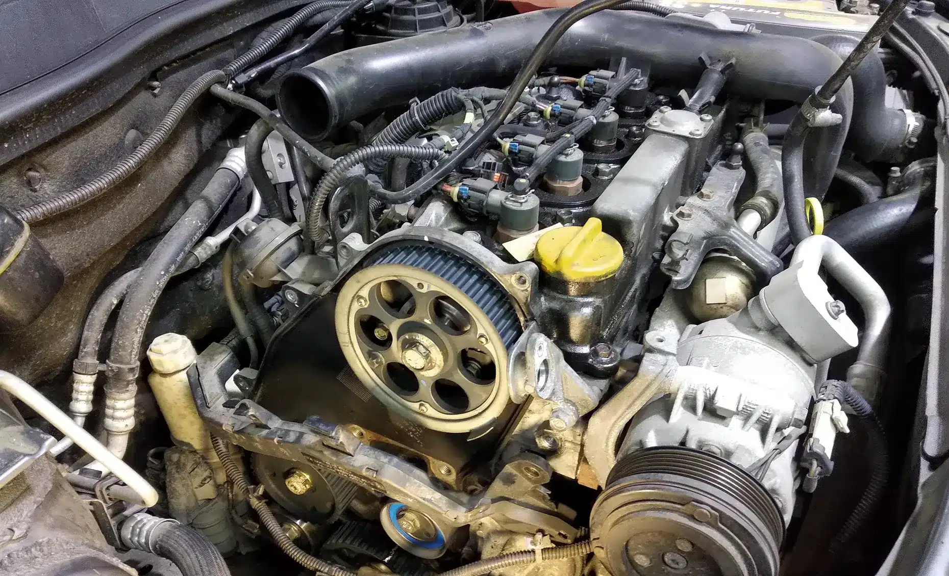 Vehicles we service, auto repair in Albuquerque, NM by Albuquerque Auto Repair and Tire. Image of an exposed engine with timing components during service, highlighting precision and performance care.