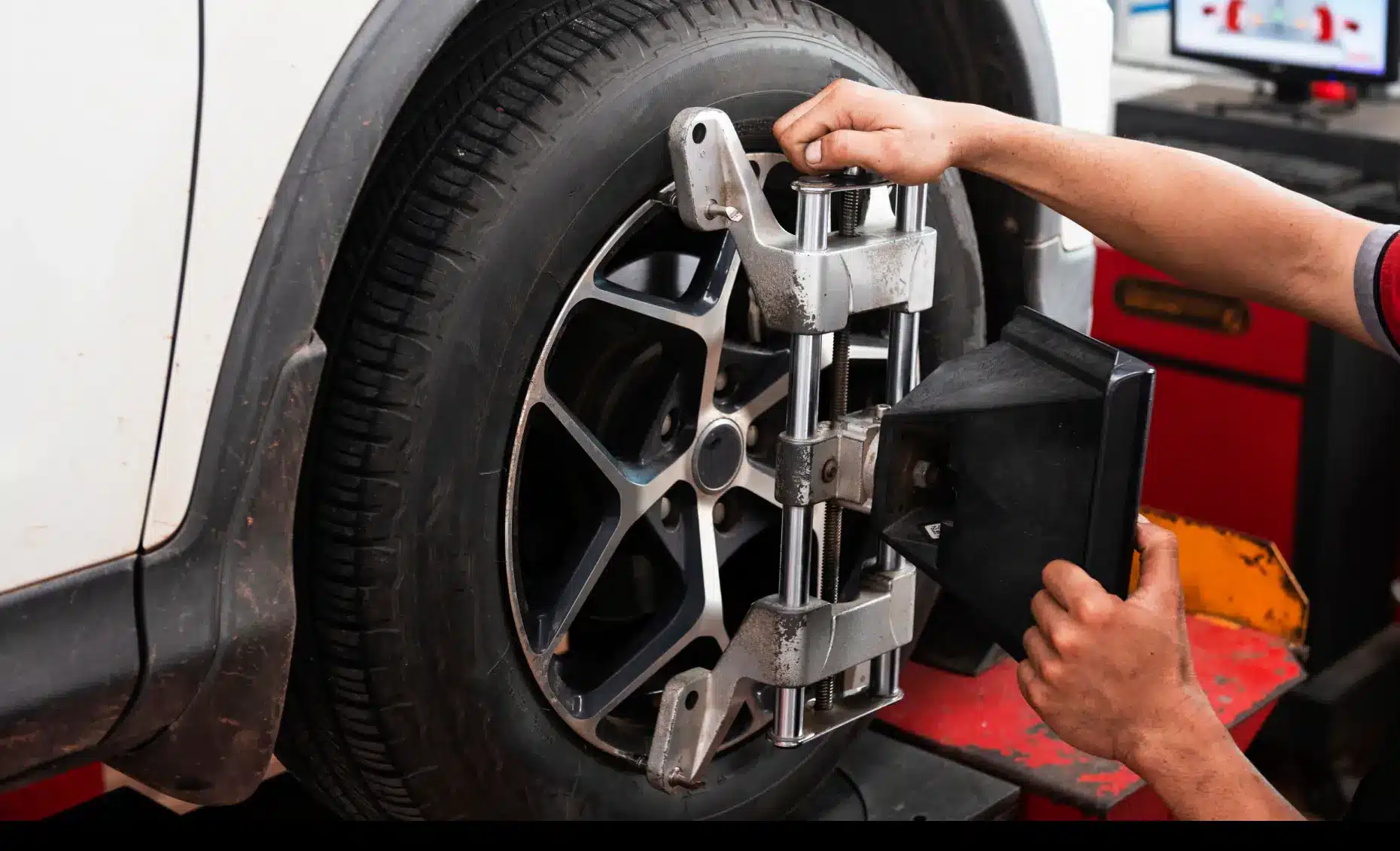 Wheel alignment in Albuquerque, NM by Albuquerque Auto Repair and Tire. Image of a technician adjusting alignment equipment on a vehicle tire, ensuring safe handling and performance.