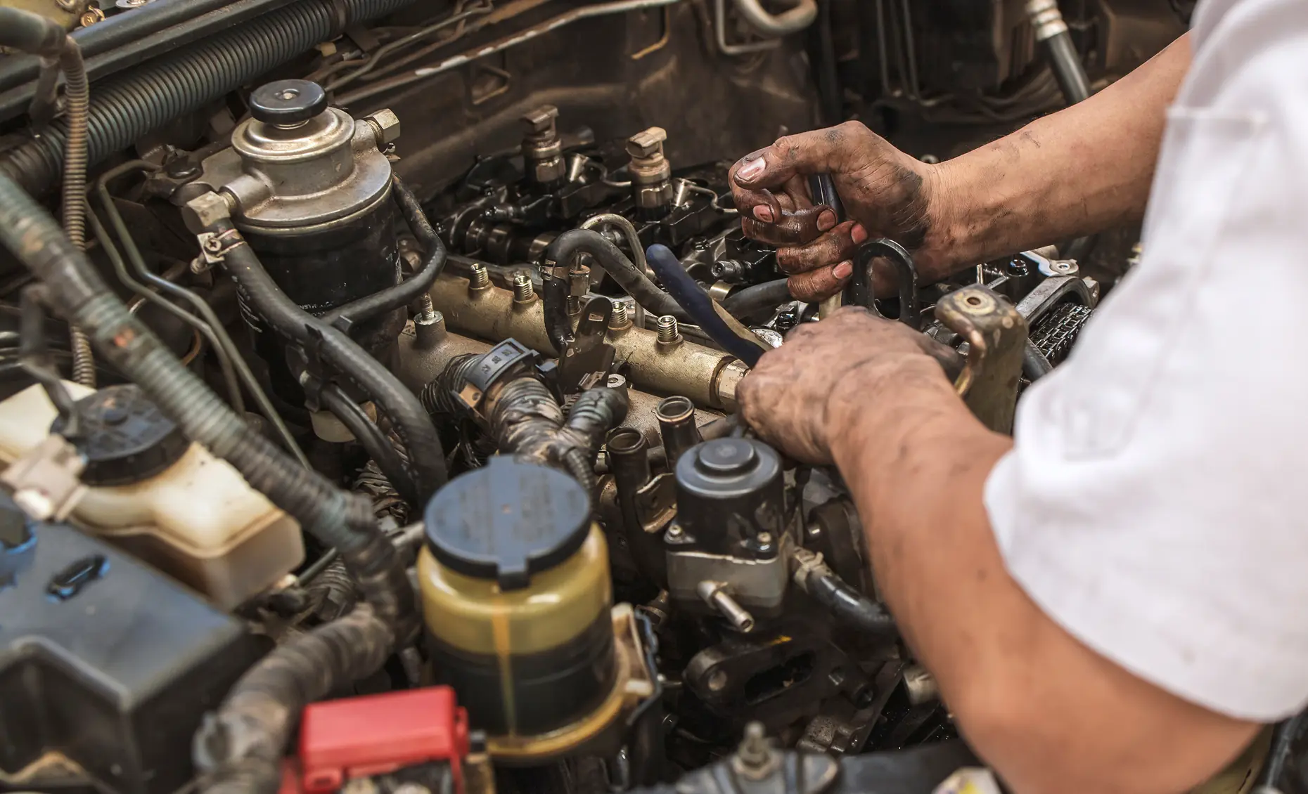Mechanic repairing an engine with tools