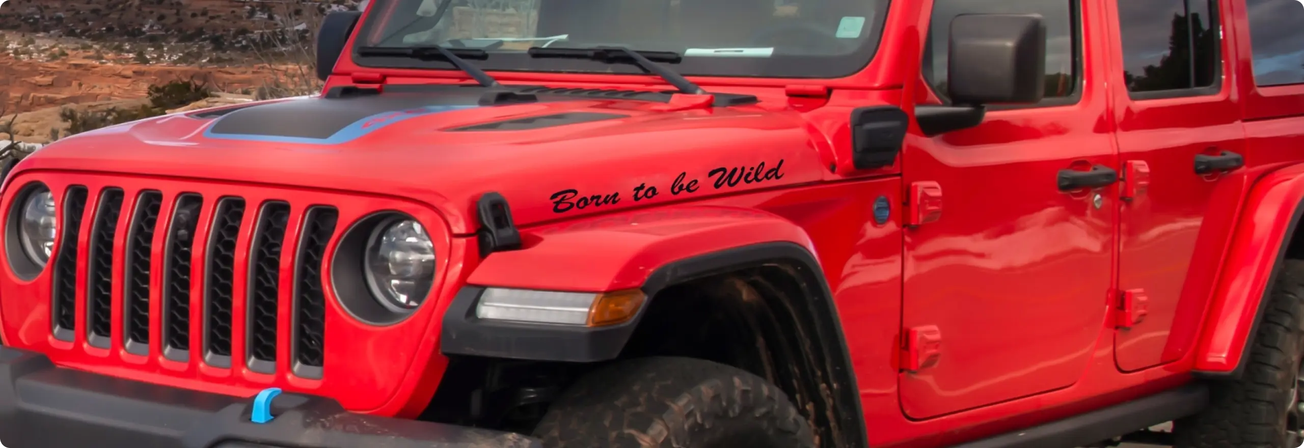 Red Jeep with adventurous slogan.