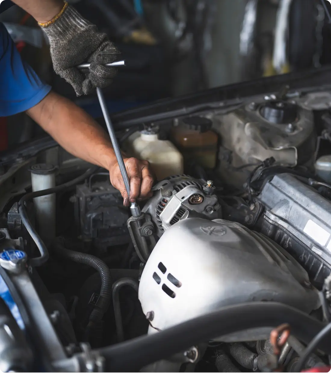 Mechanic working on car engine.
