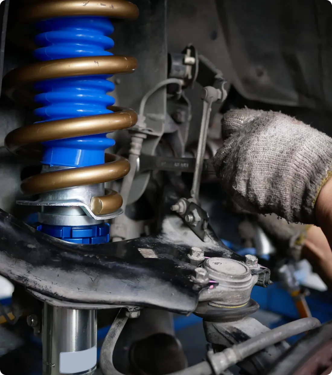Car suspension system being repaired