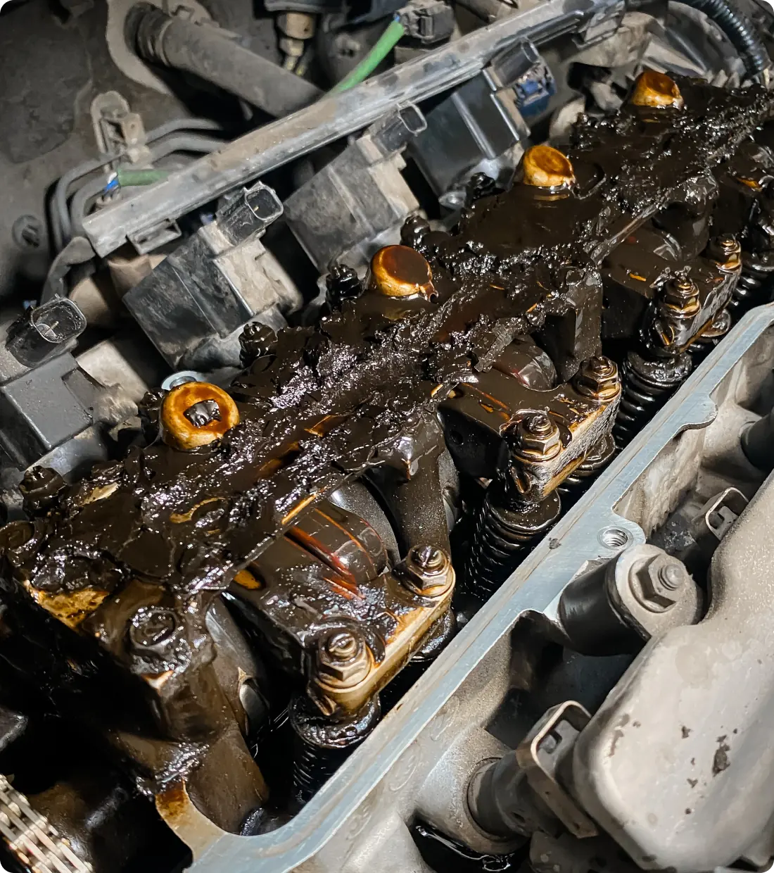 Engine valve cover with thick sludge.