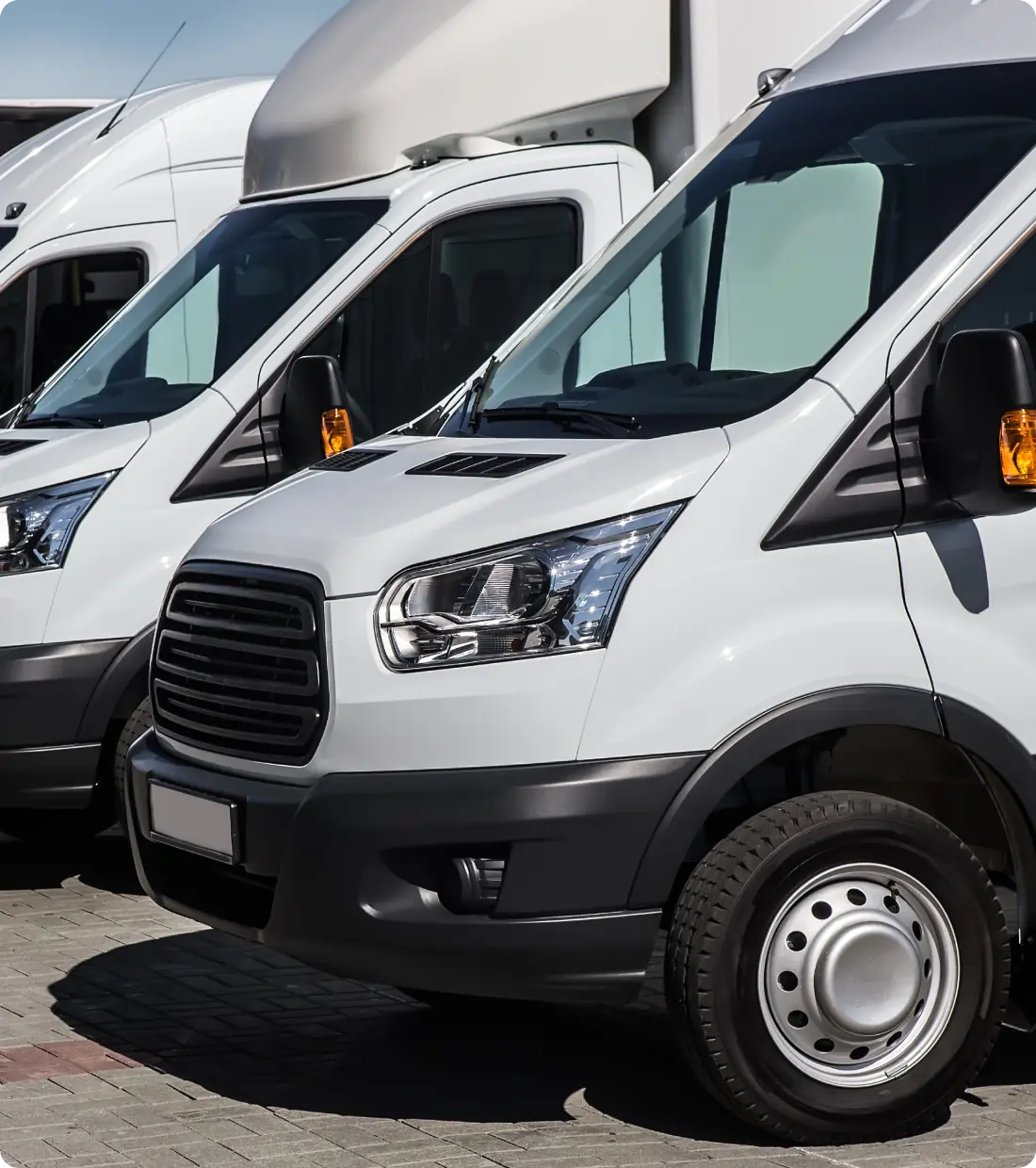 Row of white delivery vans