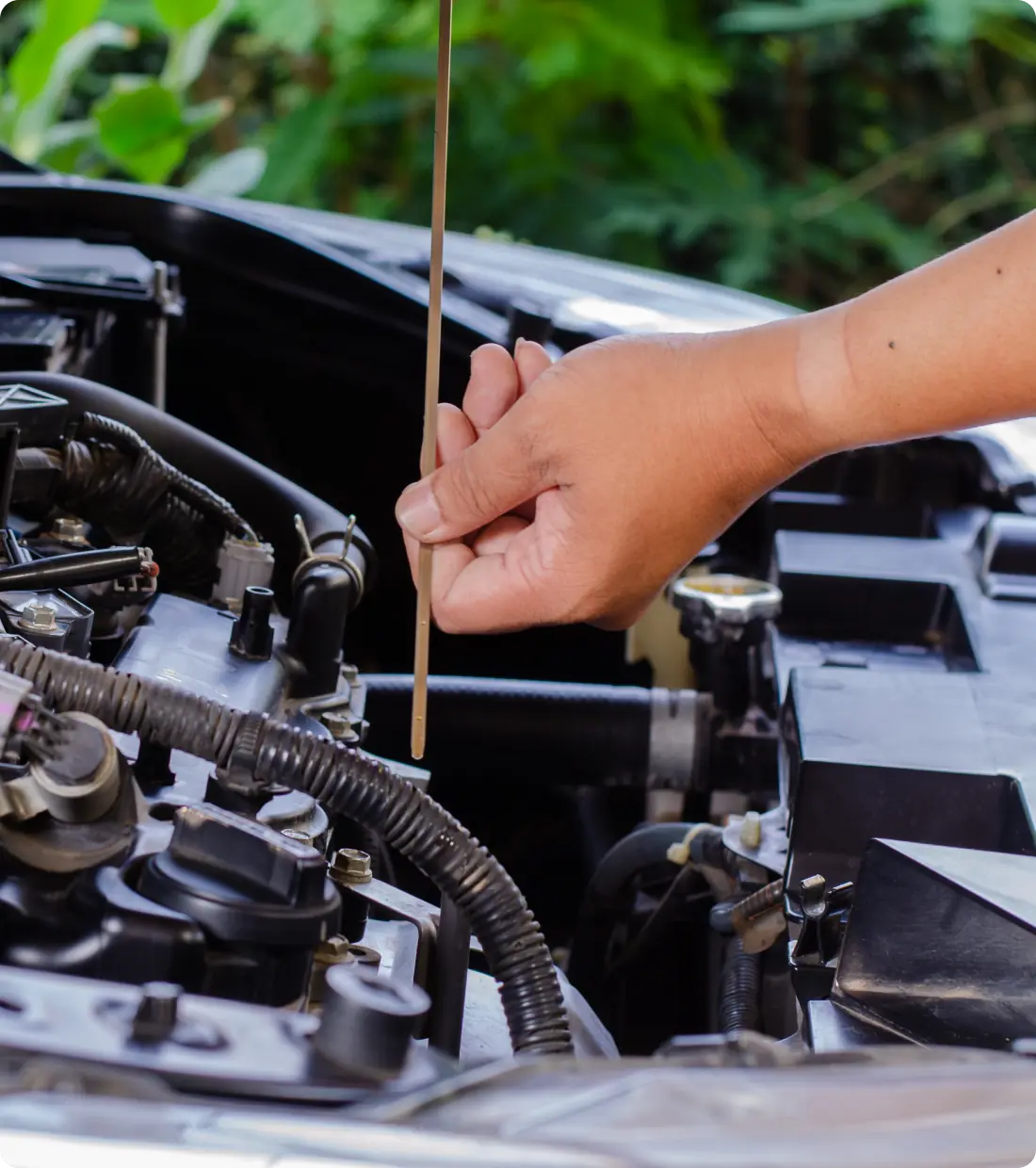 Checking engine oil level with dipstick