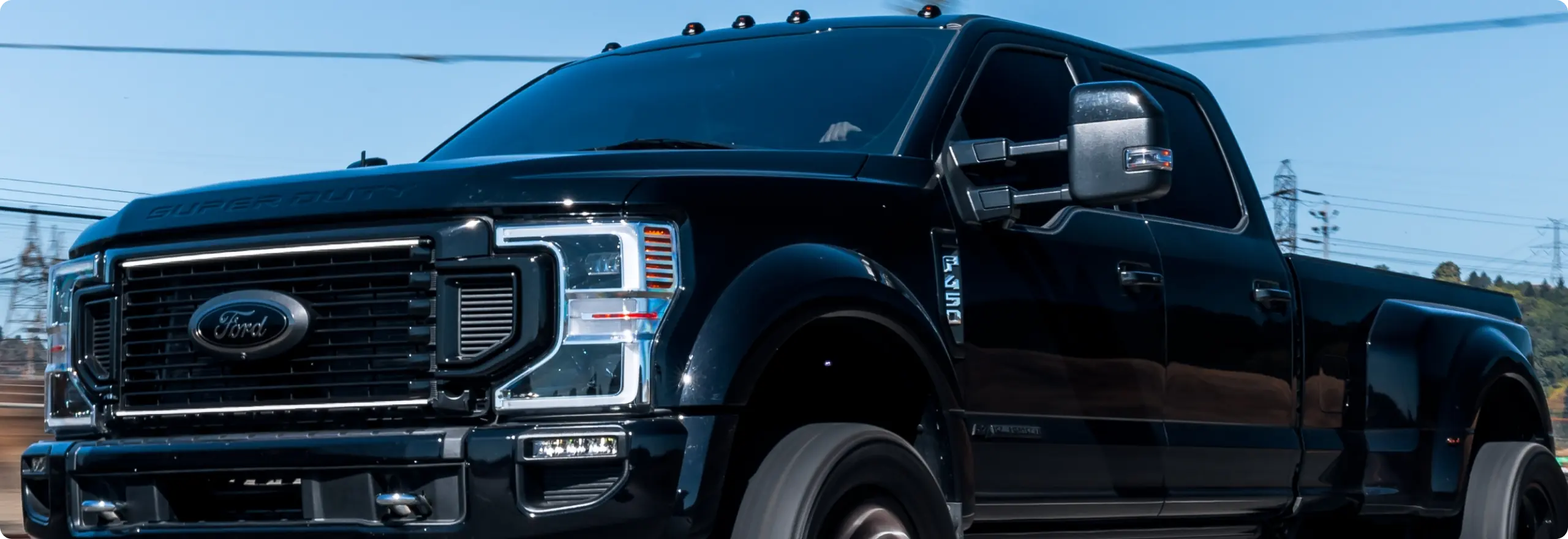 Black Ford truck in motion.