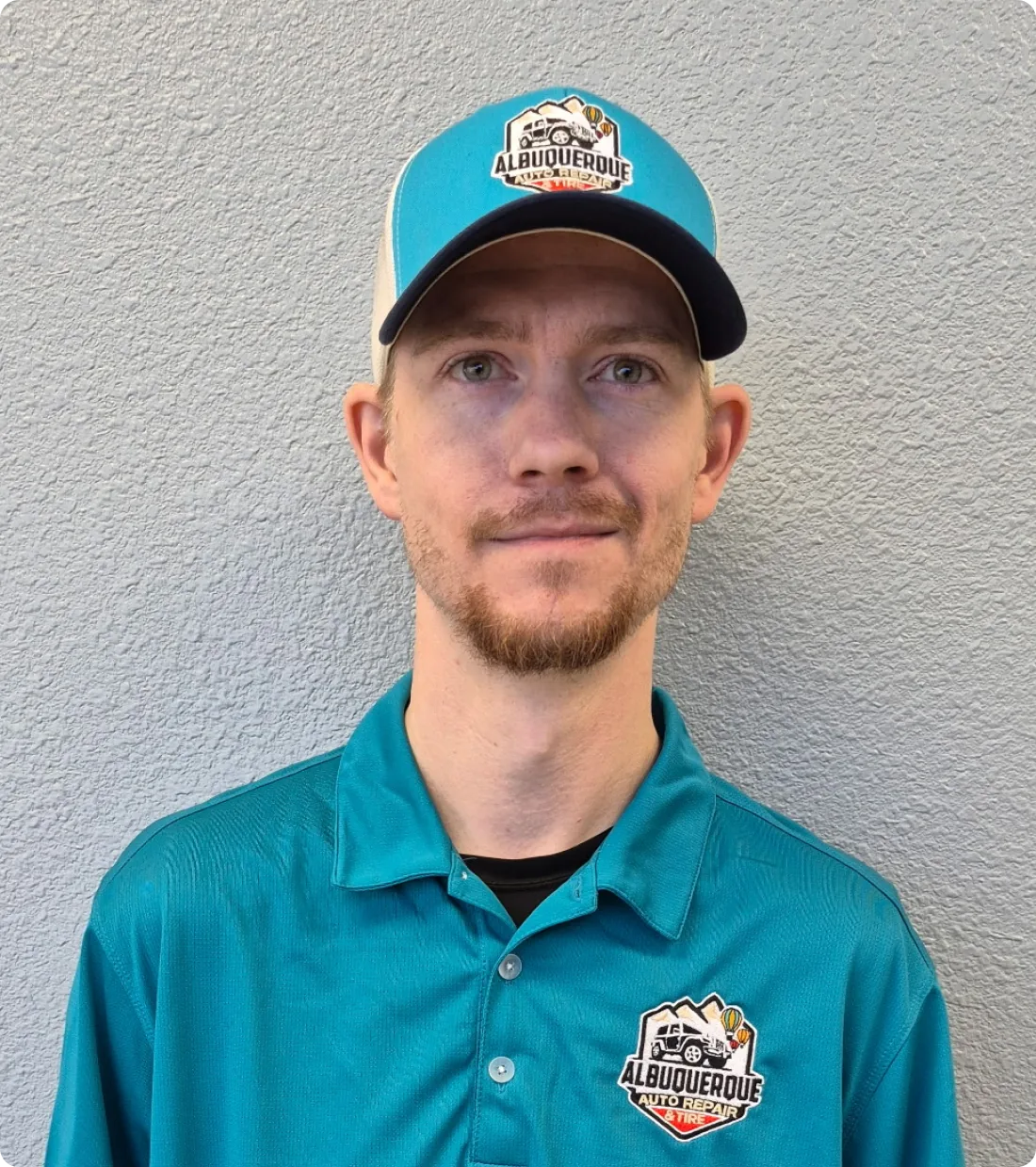 Person wearing turquoise uniform and cap.