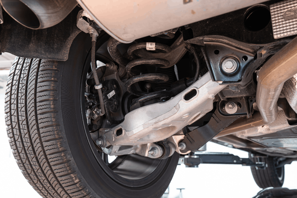 Suspension problem, auto repair in Albuquerque, NM by Albuquerque Auto Repair & Tire. Image of a vehicle’s rear suspension and control arm assembly, highlighting professional suspension diagnostics, ride stability, and safe handling performance.