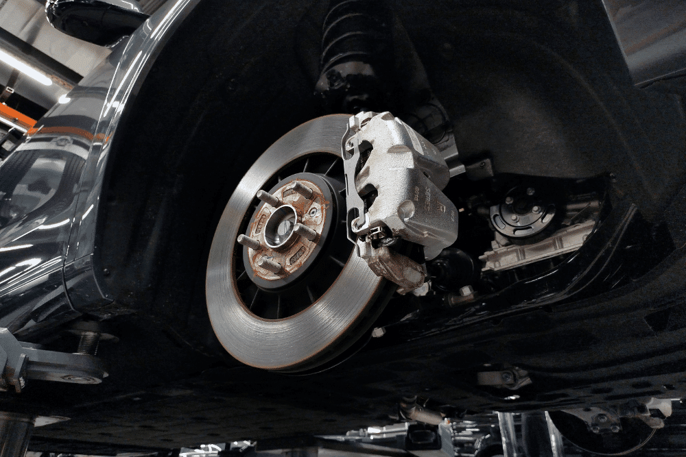 Brake repair, auto repair in Albuquerque, NM at Albuquerque Auto Repair & Tire. Image of a vehicle brake rotor and caliper during professional brake service.